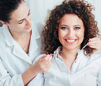 Image of a patient & a dentist, Patient smilling with showing her brighter teeth