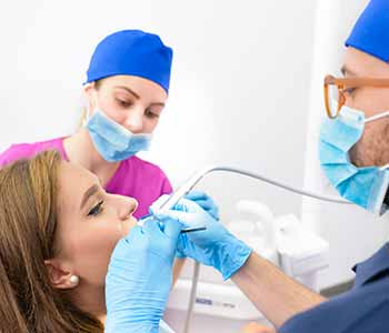 Image of a dentist checking his patient mouth