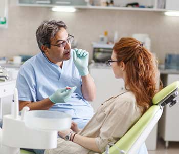 Dentist explaining about periodontal Disease to patient